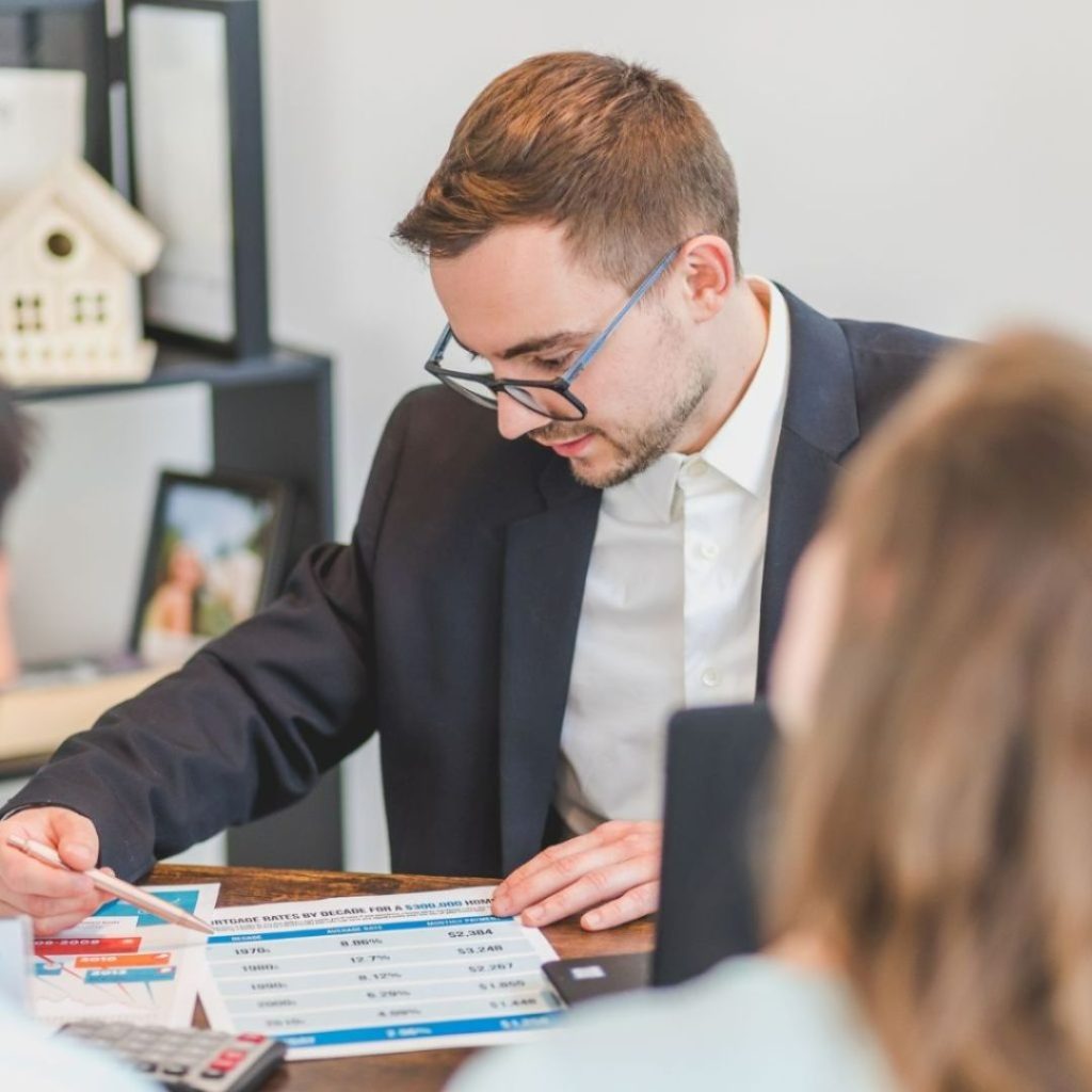 Man in suit explaining mortgage rates chart to clients