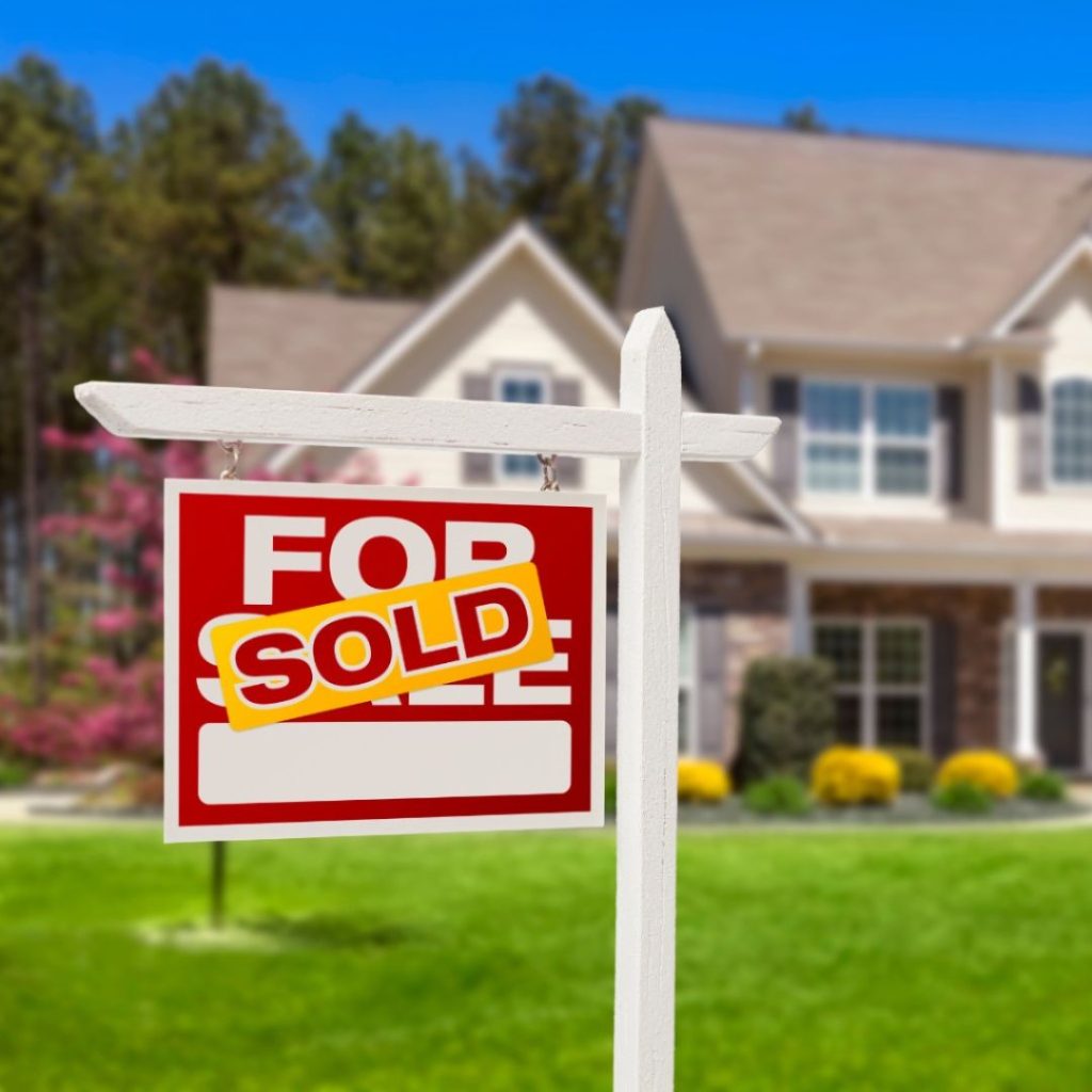 Sold sign in front of a house.