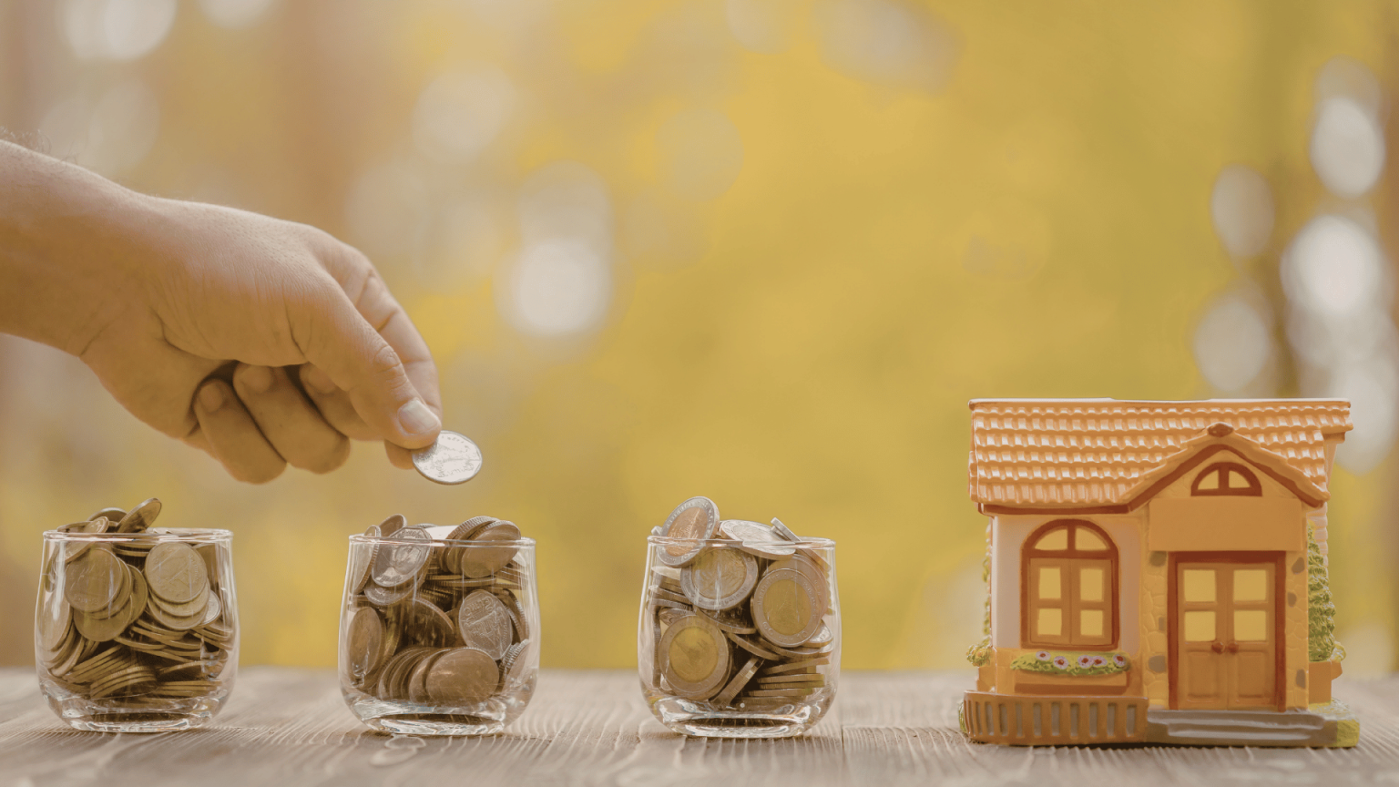 Miniature house beside three jars filled with coins representing cost savings from a flat fee MLS.