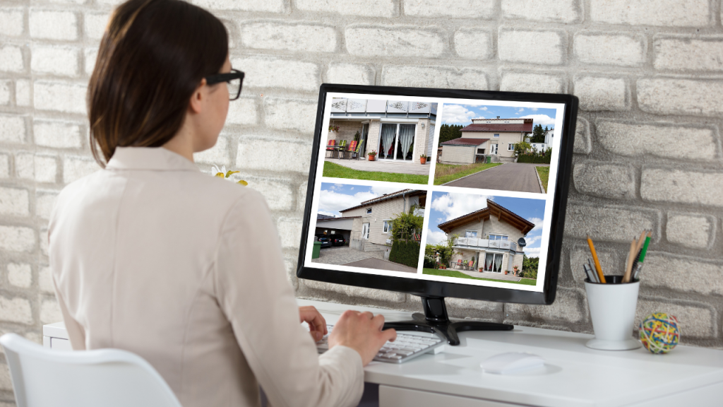 Woman browsing property listings on a desktop computer.