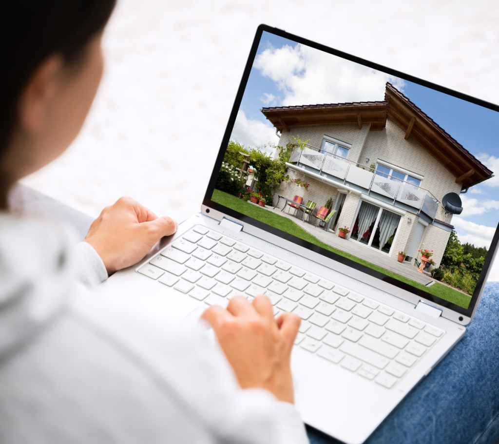 Person browsing house listings on a laptop.