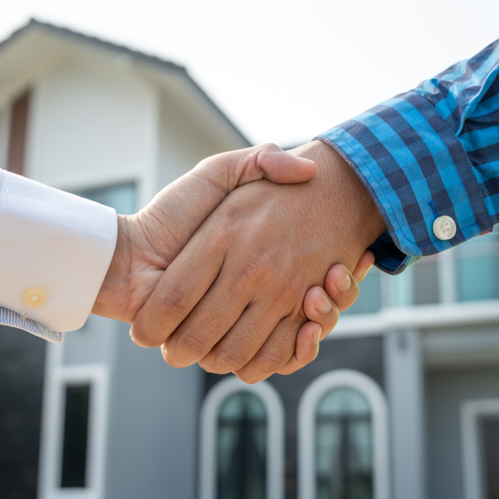 Handshake in front of house sold in texas