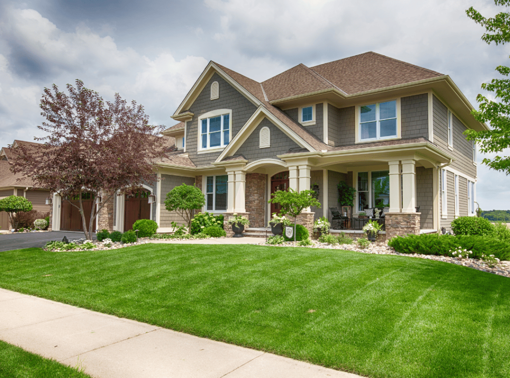 suburban house in alabama with green front yard and trees