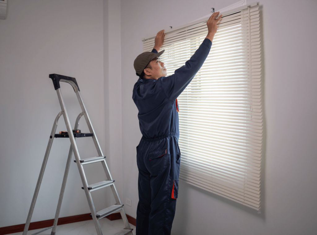 man measuring dimensions of window during home inspection
