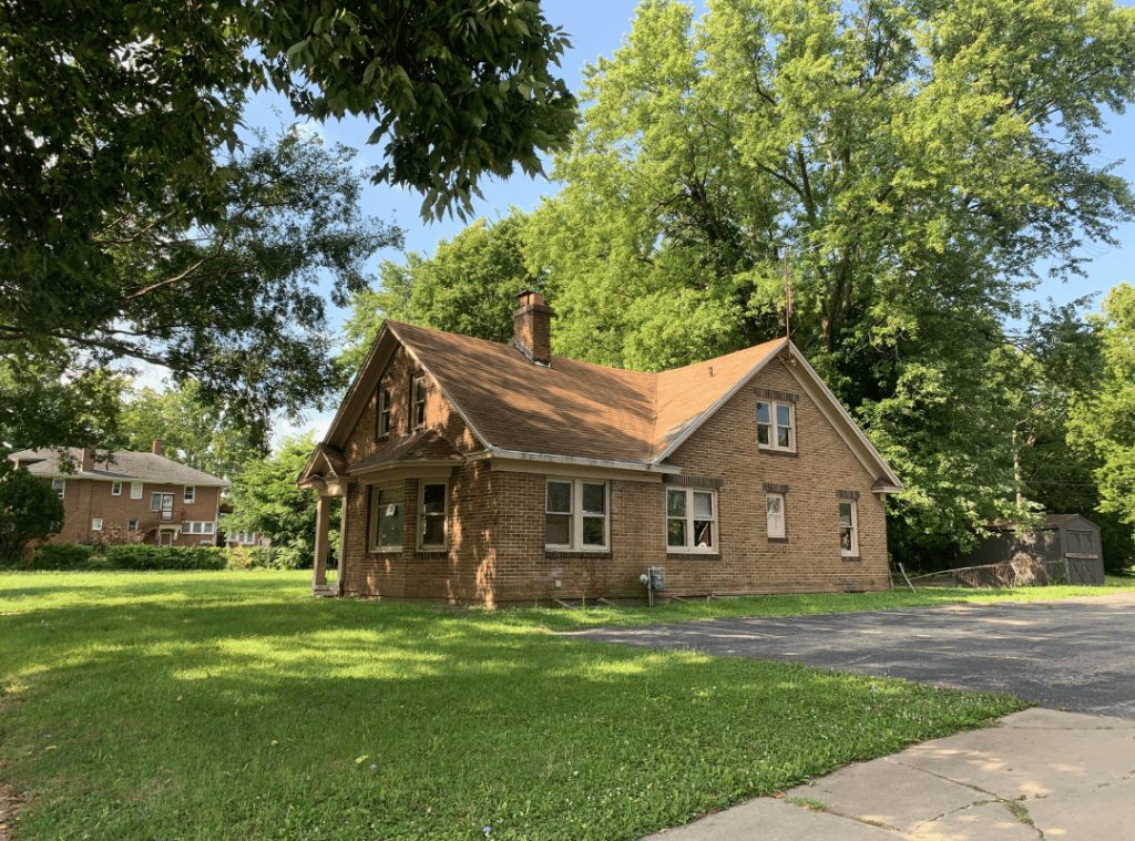 quaint brick house surrounded by green trees in illinois