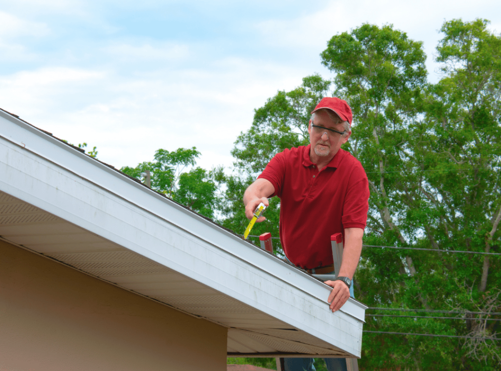 man checking roof conditions in home inspection