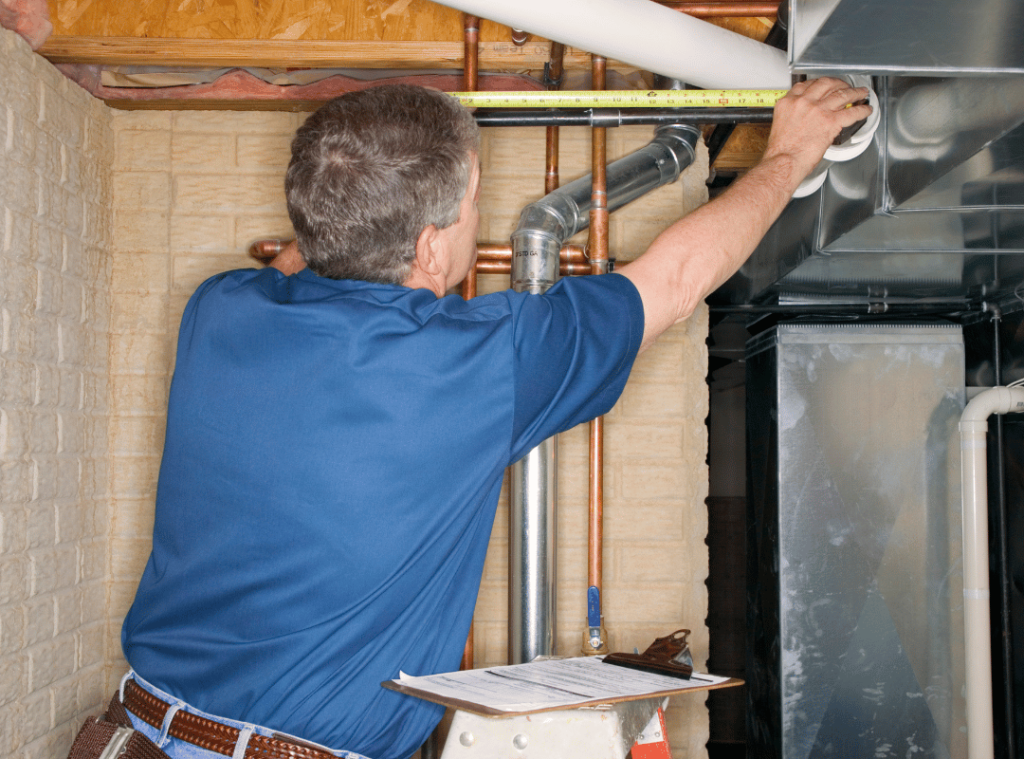man checking pipes and the conditions of pipes during house inspection