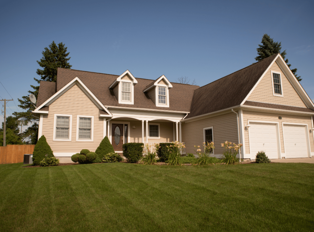 michigan family ranch style home with green front lawn