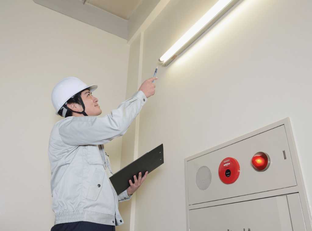 man in white helmet inspecting electric and light conditions during home inspection