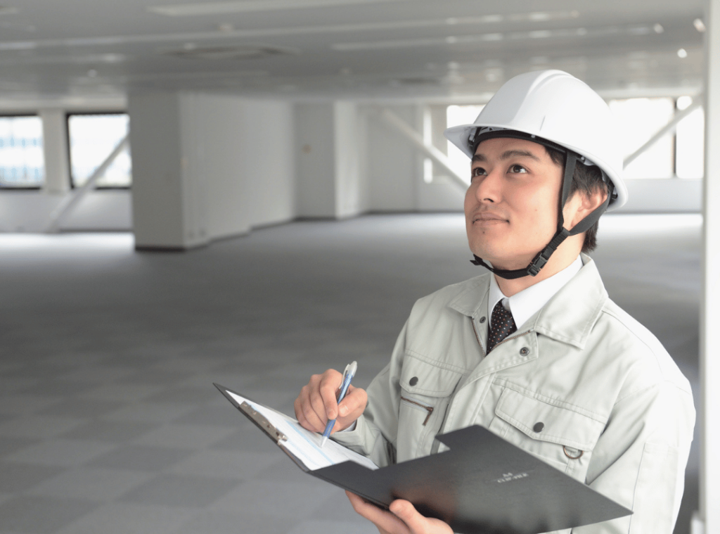 man with helmet inspecting walls and ceiling condition in home inspection