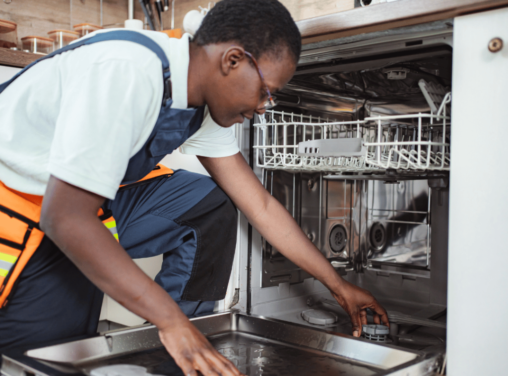 man checking dishwasher and kitchen during inspection