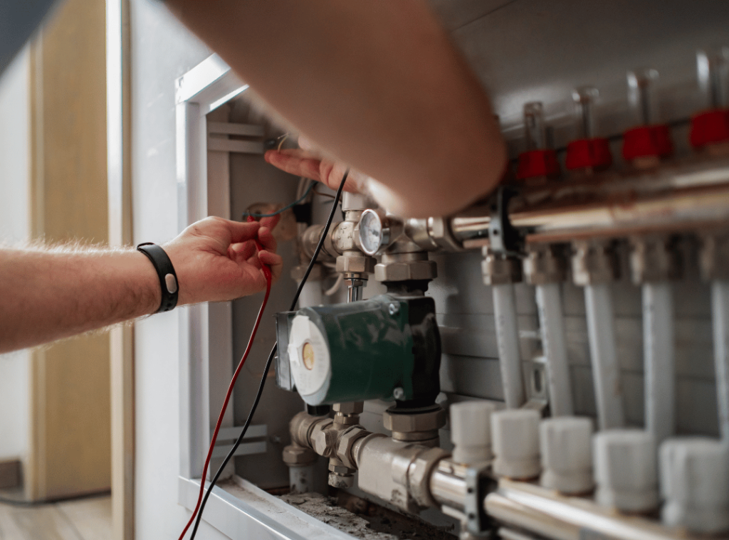 person inspecting water pressure and wires during home inspection